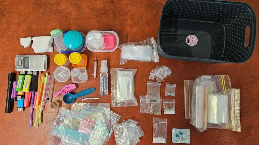 Bags of white powder and colourful containers taken from a bird's eye view.