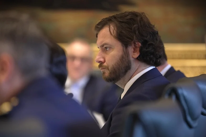 A bearded man seen in profile.