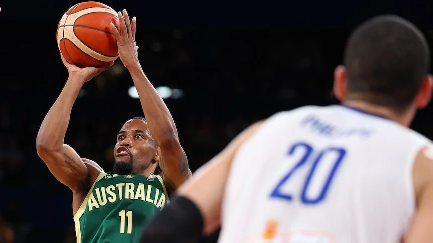 Bryce Cotton shoots against the Philippines in a FIBA World Cup qualifier, arms outstretched with the ball going for goal.