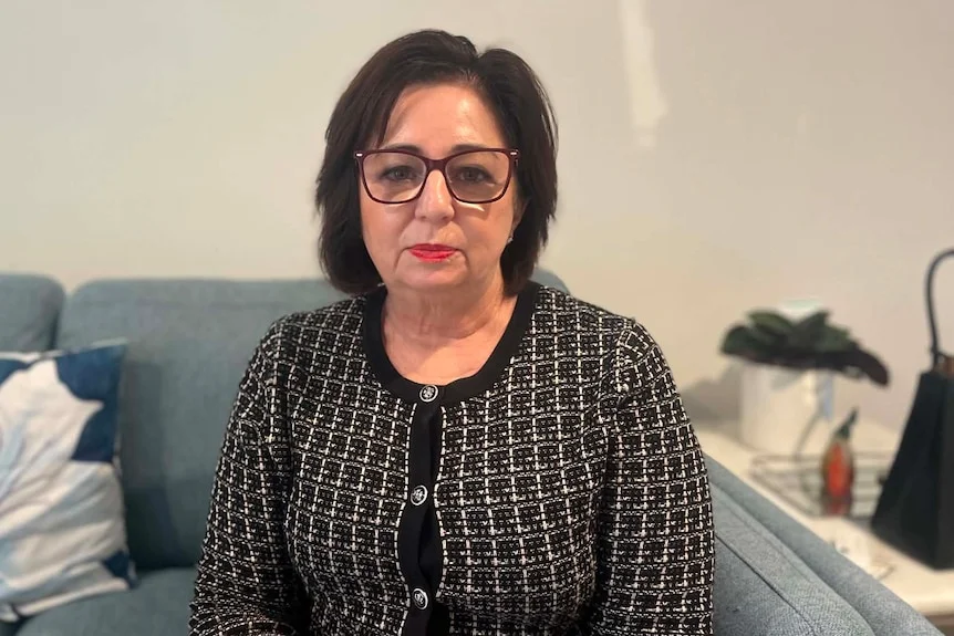 Woman with glasses, make up, looking neutral at camera