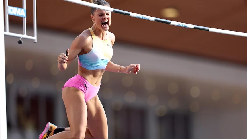 Nina Kennedy yells as she performs in the pole vault