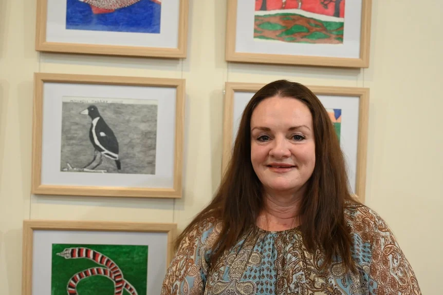 A woman in front of art.