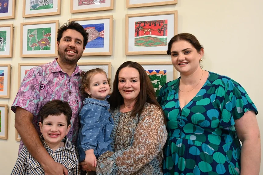 A family in front of art.
