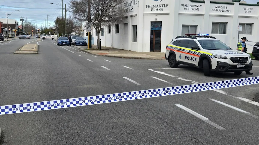 Police tape across a street outside Fremantle Glass