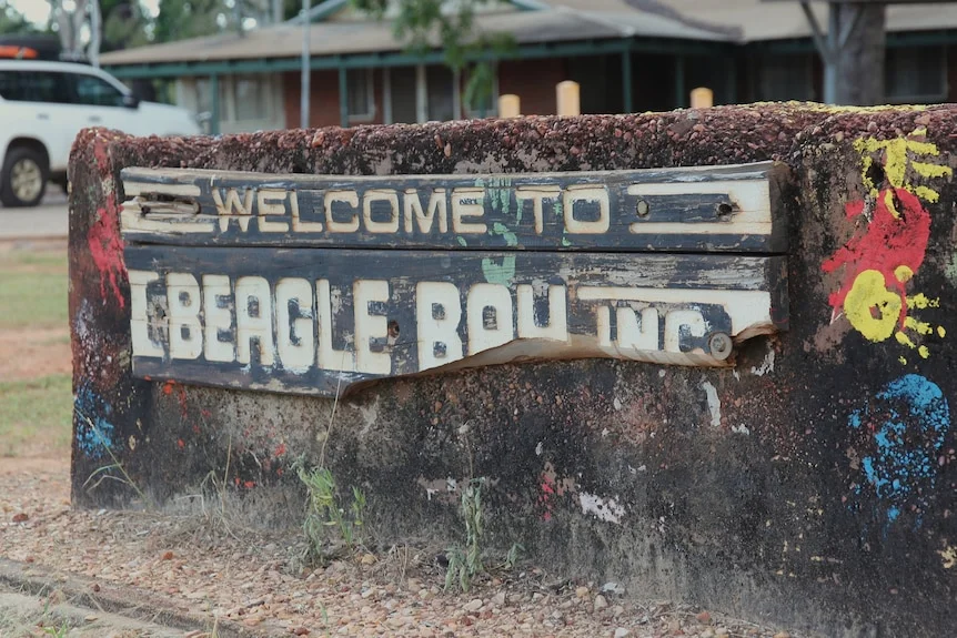 A wooden sign engraved with "welcome to Beagle Bay".