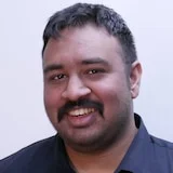 Arj Ganesan smiles for the camera.