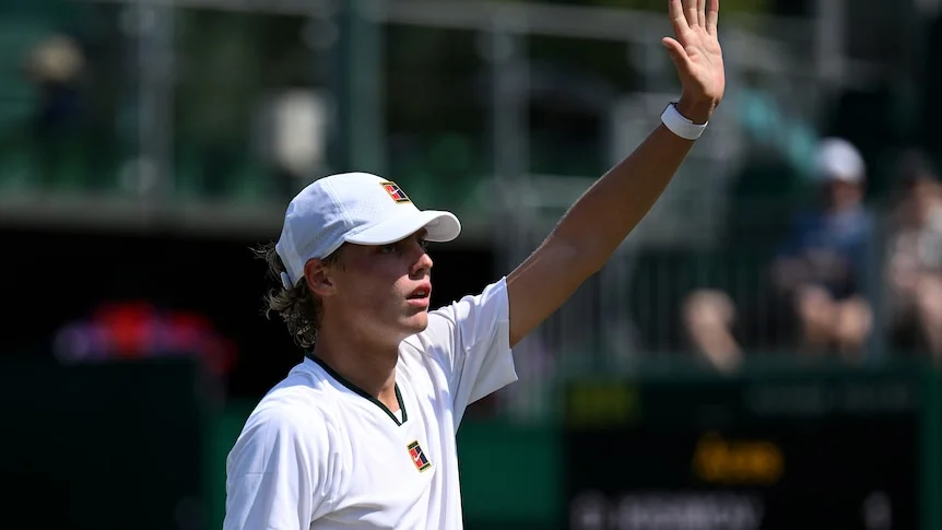 Cruz Hewitt raises his left hand up in the air