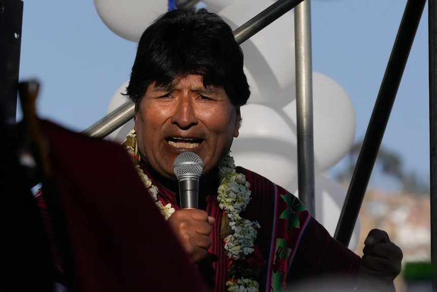 Evo Morales speaks into a mic with an emphatic expression.