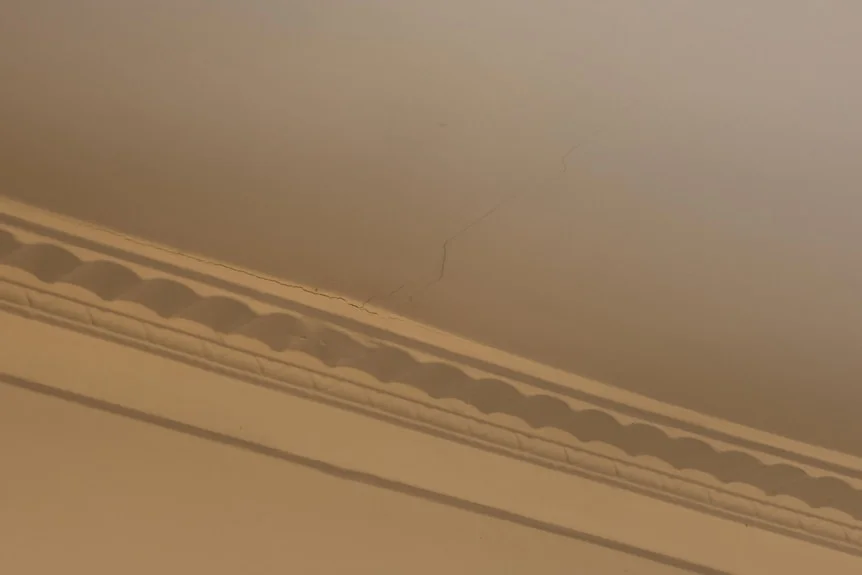 A thin hairline crack in a ceiling