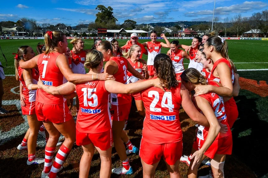 Sydney sings the club song after round one AFLW match victory.