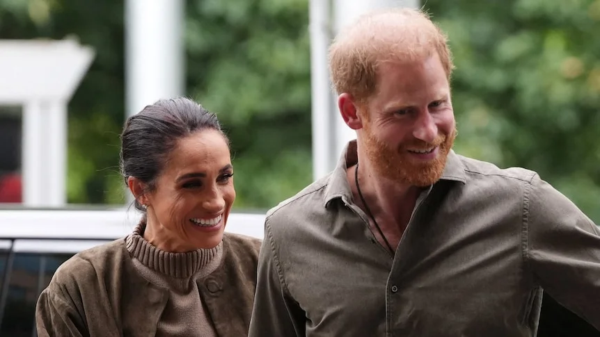 Prince Harry and Meghan get out of a car. 