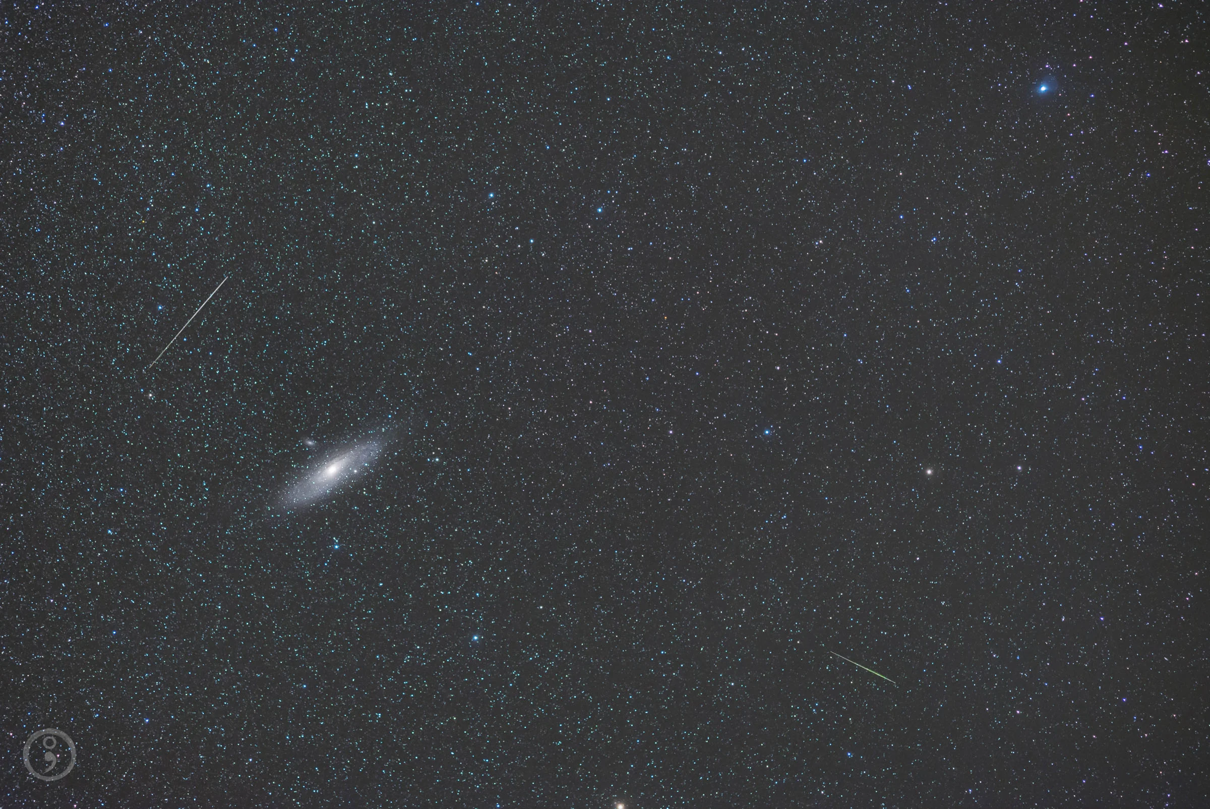 Two meteors dart across the sky near the Andromeda galaxy, the Milky Way's closest galactic neighbor, in this starry image captured by astrophotographer Omid Qadrdan.