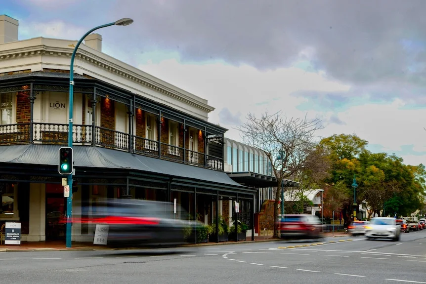 Two cars driving on a suburban street in North Adelaide
