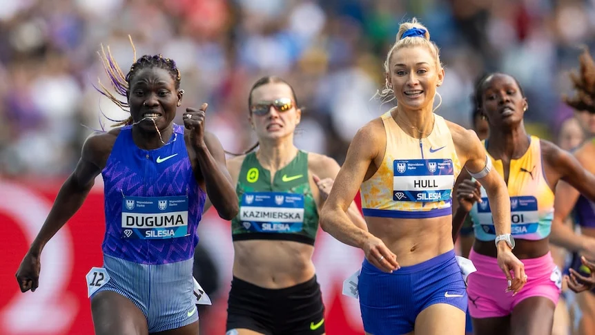 Athletes are pictured front on running towards the finish line.