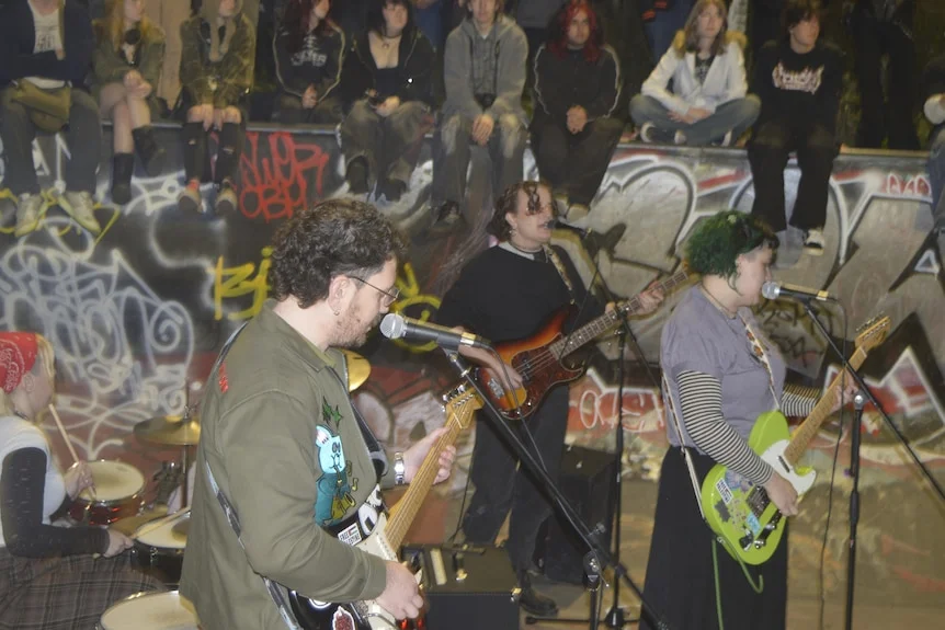 a band plays in a skate park