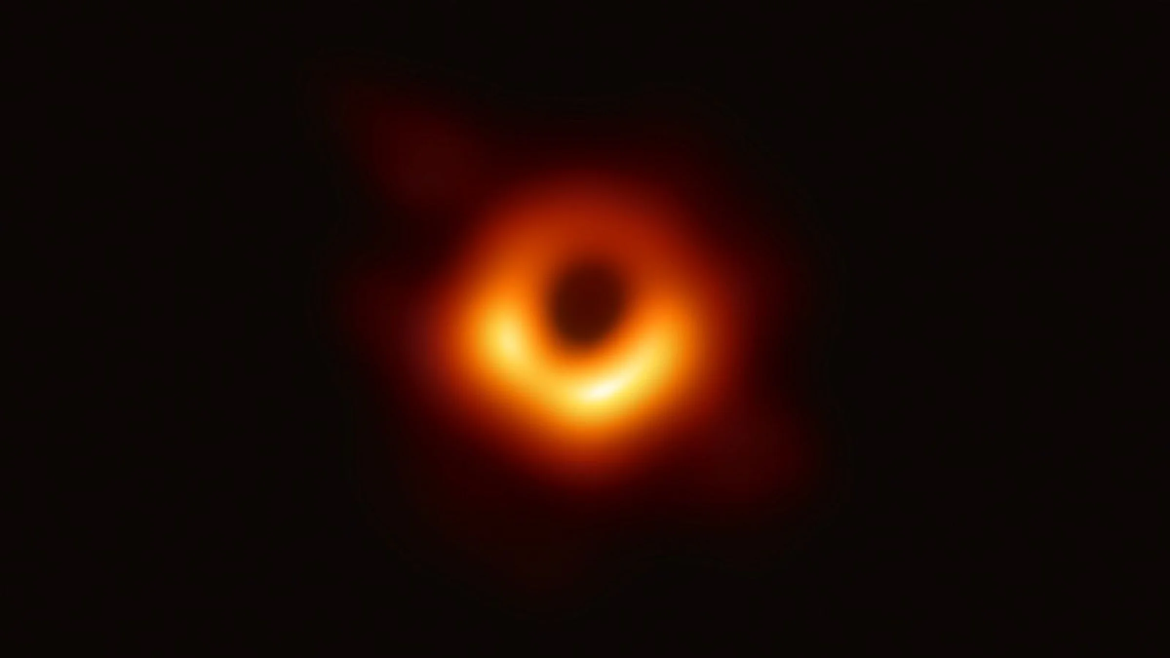 The first direct image of a black hole showing a blurry ring of orange around a central dark point