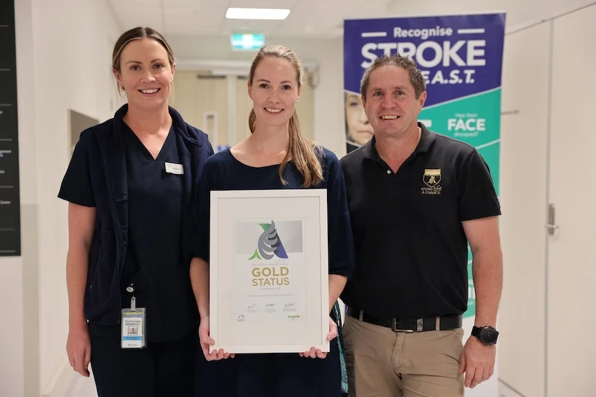 Stroke team holding an award