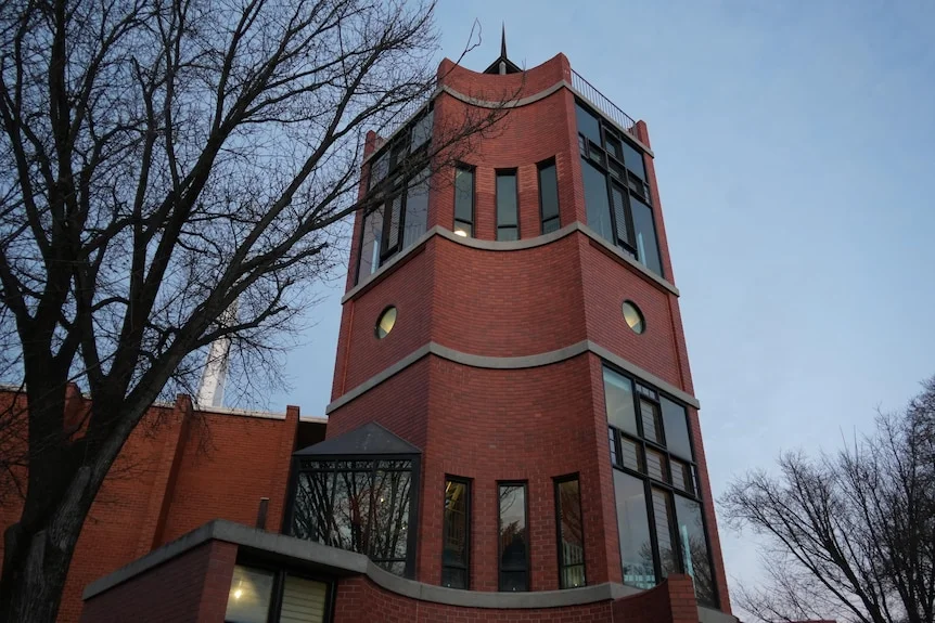 A modern church tower at dusk.