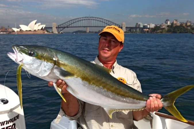 Man holding a fish on a boat