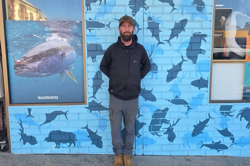 Person standing next to wall