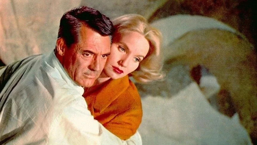 Film still of Eva Marie Saint and Cary Grant clutching each other dramatically