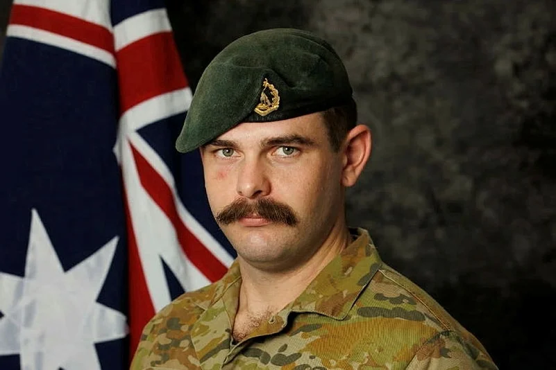 Corporal Brendan Hannam wears a serious facial expression while dressed in his army uniform.