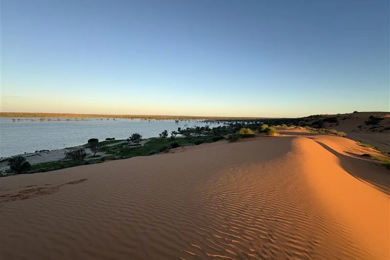 red sand dune, water