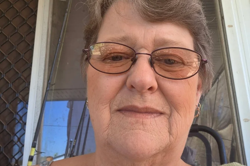 Older white lady sitting in a chair 