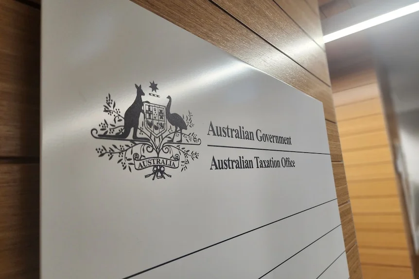 A sign on a wall says Australian Government Australian Taxation Office.