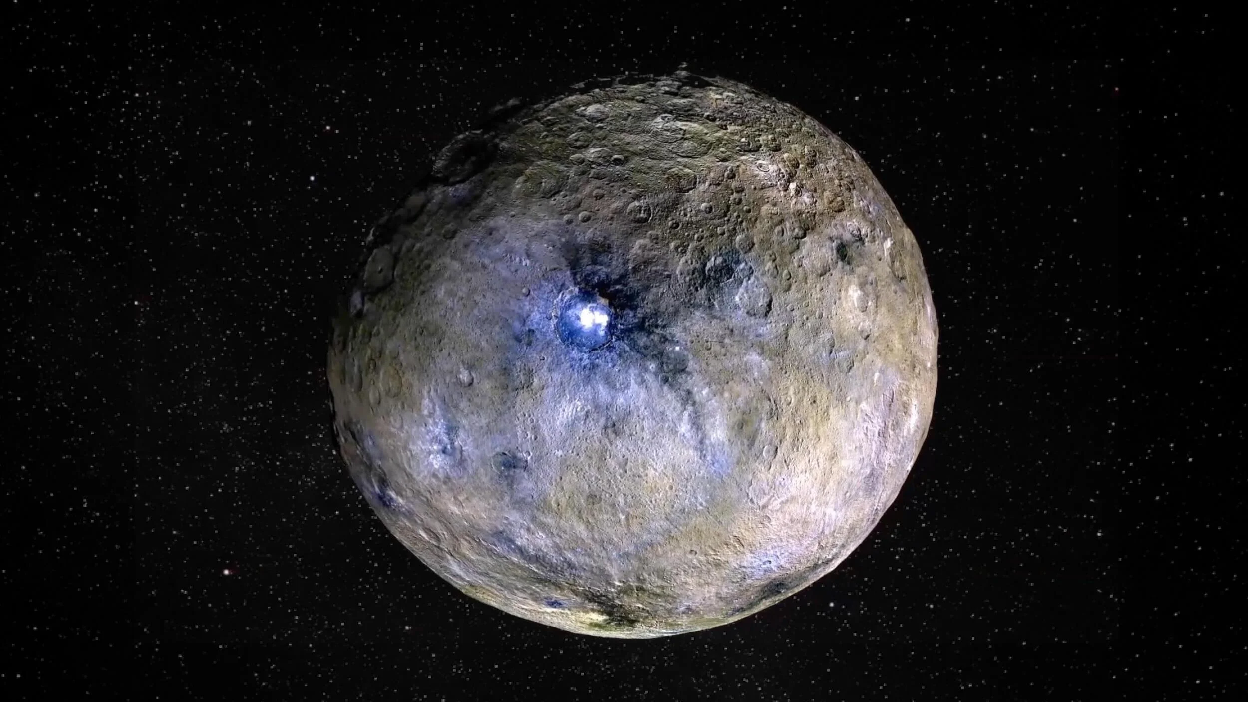 A cratered, spherical celestial body with a bright spot on its surface floats in dark outer space dotted with stars.