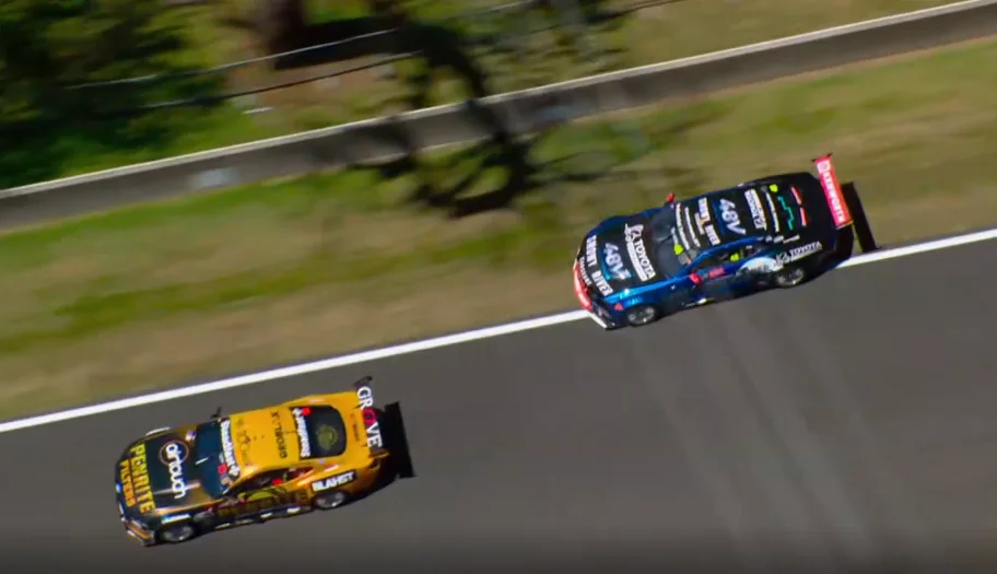 Car on the grass and and leading car stays on the track