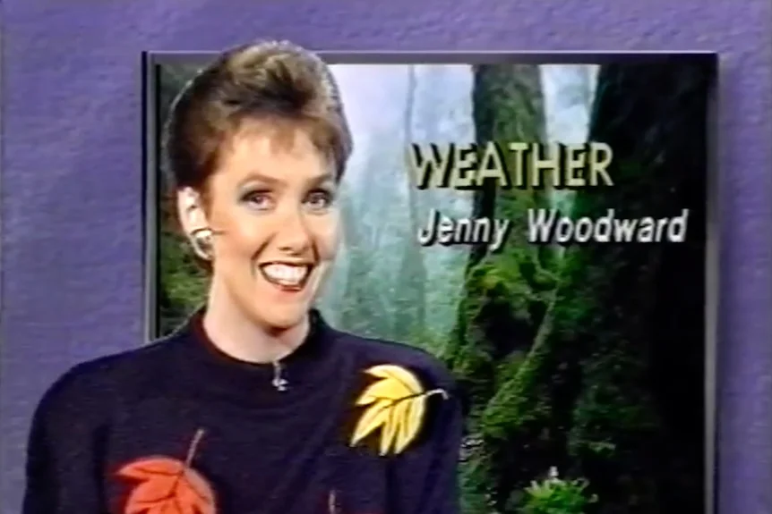 Head shot of Jenny Woodward smiling with words Weather Jenny Woodward on a screen in the background.