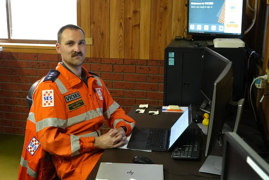 A man in SES uniform sitting in front of a desk