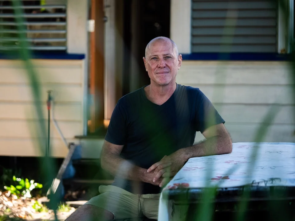 A portrait shot of a man in a blue shirt.